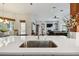 Modern kitchen sink and faucet with a view into the living room at 510 Golfpark Dr, Celebration, FL 34747