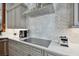 Modern kitchen features a sleek cooktop and stylish backsplash at 510 Golfpark Dr, Celebration, FL 34747