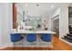 Open kitchen with breakfast bar and blue velvet stools at 510 Golfpark Dr, Celebration, FL 34747