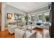 Spacious living area featuring hardwood floors and access to the pool area at 510 Golfpark Dr, Celebration, FL 34747