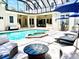 Relaxing pool and spa with patio furniture and covered seating at 510 Golfpark Dr, Celebration, FL 34747