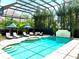 Enclosed pool area with lounge chairs and umbrellas at 510 Golfpark Dr, Celebration, FL 34747