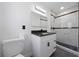 Bathroom featuring a modern vanity with a black countertop, and a shower with marble wall and dark accents at 5438 San Luis Dr, Orlando, FL 32807