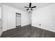 Bedroom featuring a ceiling fan, gray floors, white walls, and a closet with sliding doors at 5438 San Luis Dr, Orlando, FL 32807