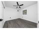 Bedroom with a ceiling fan, gray floors, white walls, and a window at 5438 San Luis Dr, Orlando, FL 32807