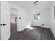 Bright bedroom featuring gray flooring, modern trim, and a window for natural light at 5438 San Luis Dr, Orlando, FL 32807