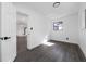 Bedroom featuring gray floors, white walls, and a door leading into the large basement area at 5438 San Luis Dr, Orlando, FL 32807