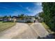 Inviting single-story home showcasing a spacious driveway and well-kept landscaping at 5438 San Luis Dr, Orlando, FL 32807