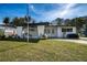 Inviting single-story home with covered entryway, showcasing its well-maintained front yard at 5438 San Luis Dr, Orlando, FL 32807