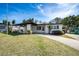 Charming single-story home with a well-manicured lawn and inviting covered entryway at 5438 San Luis Dr, Orlando, FL 32807