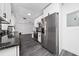 Modern kitchen with stainless steel appliances, black marble backsplash, and sleek white cabinets at 5438 San Luis Dr, Orlando, FL 32807