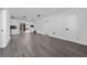Spacious open-concept living room with stone fireplace, new gray laminate flooring, and ample natural light at 5438 San Luis Dr, Orlando, FL 32807