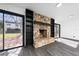 Living room featuring a stone fireplace, built-in shelving, sliding glass doors, and gray wood-look flooring at 5438 San Luis Dr, Orlando, FL 32807