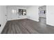 Bright living room with gray laminate flooring, modern fixtures, and a view of the front entry at 5438 San Luis Dr, Orlando, FL 32807