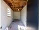 Empty shed interior revealing exposed rafters and cement walls, offering ample storage space at 5438 San Luis Dr, Orlando, FL 32807