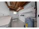 Well-lit utility room featuring a newer water heater and ample workspace at 5438 San Luis Dr, Orlando, FL 32807