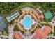 Overhead shot of clubhouse area with pool, bocce ball, tennis courts, and outdoor lounging at 663 Shorehaven Dr, Poinciana, FL 34759