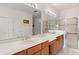 Bright bathroom features double sinks and glass-enclosed shower at 663 Shorehaven Dr, Poinciana, FL 34759
