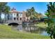 A stone bridge leads to a quaint building with a red tile roof, offering a picturesque view at 663 Shorehaven Dr, Poinciana, FL 34759