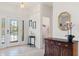 Welcoming foyer with tiled floors, elegant decor, and a view into a half bathroom at 663 Shorehaven Dr, Poinciana, FL 34759