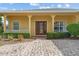 Inviting front entrance with a brick paver driveway and a stylish front door with glass panels at 663 Shorehaven Dr, Poinciana, FL 34759