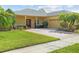 Charming single-story home with a brick driveway, mature landscaping, and a welcoming front porch at 663 Shorehaven Dr, Poinciana, FL 34759