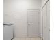 The laundry area offers tiled flooring, modern appliances and leads to additional storage at 663 Shorehaven Dr, Poinciana, FL 34759