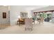 Bright living room with neutral carpet, white walls, comfortable seating, and sliding glass doors to the lanai at 663 Shorehaven Dr, Poinciana, FL 34759
