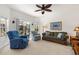 Relaxing living room with comfortable seating, a ceiling fan, and sliding glass doors to the lanai at 663 Shorehaven Dr, Poinciana, FL 34759