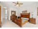 Bedroom with wooden bed frame, matching furniture set, and neutral carpeting at 663 Shorehaven Dr, Poinciana, FL 34759