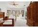 Spacious bedroom with large windows, decorative curtains, and a ceiling fan at 663 Shorehaven Dr, Poinciana, FL 34759