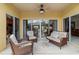Covered patio features comfortable seating and ceiling fan at 663 Shorehaven Dr, Poinciana, FL 34759