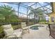 Enjoy the hot tub in the screened lanai surrounded by lush landscaping at 663 Shorehaven Dr, Poinciana, FL 34759