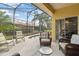 Screened patio features a hot tub and outdoor seating at 663 Shorehaven Dr, Poinciana, FL 34759