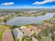 Community overview featuring lake, lush landscape, and homes at 669 Grand Canal Dr, Kissimmee, FL 34759