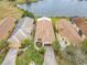 Bird's-eye view of lakefront homes with solar panels at 669 Grand Canal Dr, Kissimmee, FL 34759