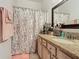 Bathroom with granite countertop, shower/tub combo and updated fixtures at 669 Grand Canal Dr, Kissimmee, FL 34759