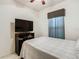 Bedroom with a double bed, TV stand and window coverings at 669 Grand Canal Dr, Kissimmee, FL 34759