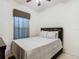Bright bedroom with double bed, ceiling fan and window coverings at 669 Grand Canal Dr, Kissimmee, FL 34759