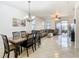 Bright dining room with a large wooden table and access to the living room at 669 Grand Canal Dr, Kissimmee, FL 34759