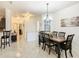Well-lit dining room with dark wood table and six chairs at 669 Grand Canal Dr, Kissimmee, FL 34759