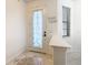 Front entry with white door and decorative glass at 669 Grand Canal Dr, Kissimmee, FL 34759