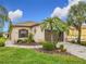 Single-story home with attractive landscaping and paver driveway at 669 Grand Canal Dr, Kissimmee, FL 34759