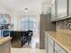 Modern kitchen with stainless steel appliances and granite countertops at 669 Grand Canal Dr, Kissimmee, FL 34759
