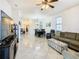 Open living room with sectional sofa, ottoman, and access to dining area at 669 Grand Canal Dr, Kissimmee, FL 34759