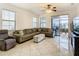 Relaxing living room, featuring a sectional sofa and access to a patio at 669 Grand Canal Dr, Kissimmee, FL 34759