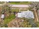 Aerial view of a charming property with lush backyard, patio, shed and mature trees at 723 New York Ave, St Cloud, FL 34769