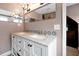 Upscale bathroom featuring a double vanity with marble countertops, designer tile, and stylish lighting fixtures at 723 New York Ave, St Cloud, FL 34769