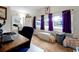 Bedroom with a large window with purple curtains and a desk; perfect for a home office or study at 723 New York Ave, St Cloud, FL 34769