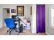 Bedroom with a large window and purple curtain, complete with a desk and ample storage solutions at 723 New York Ave, St Cloud, FL 34769